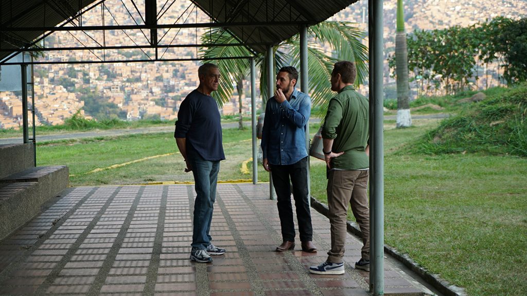 Joe Toft, Doug Laux, and Ben Smith have a chat underneath a covered patio in Medellin.